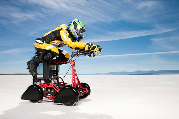 Barstool Speedster Action shot of a futuristic barstool racer zipping across the barren salt flats. Vehicle is a custom built one-of-a-kind item and has an electric motor that propels it to nearly 60mph. bonneville salt flats stock pictures, royalty-free photos & images