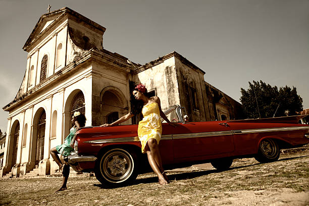 istock Two beautiful women posing with a red car 108347913