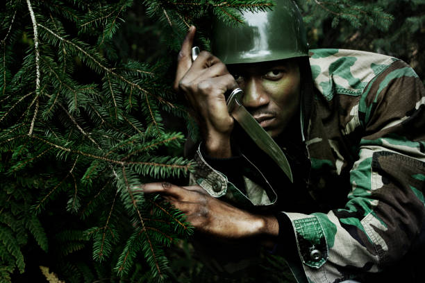 Soldier skulking in the forest ready to attack.