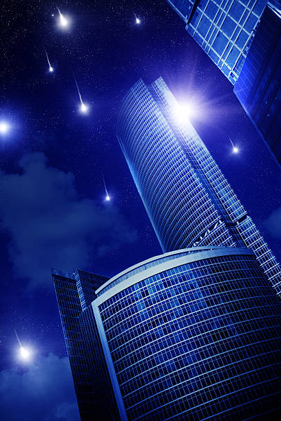 A striking nighttime cityscape featuring three modern glass skyscrapers illuminated by ambient light. The reflective surfaces capture the warm hues of the fading sunset and the glow of urban lights, creating a mesmerizing contrast against the dark night sky. A luminous full moon adds an ethereal touch to the composition, enhancing the futuristic and surreal aesthetic.