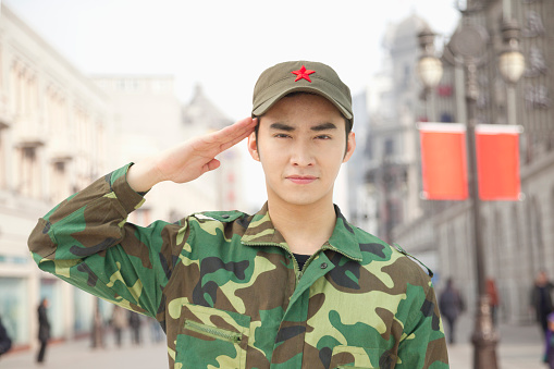 Chinese soldier in uniform saluting