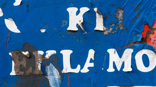 istock Old city wall in paint and torn posters 1083481268