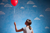 Little Girl Holding A Red Baloon