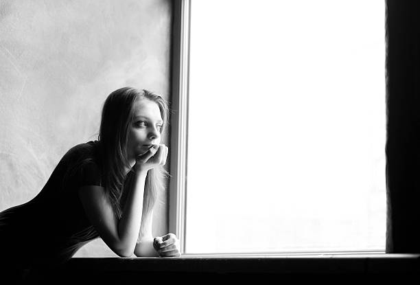 istock Young woman at the window 108348329