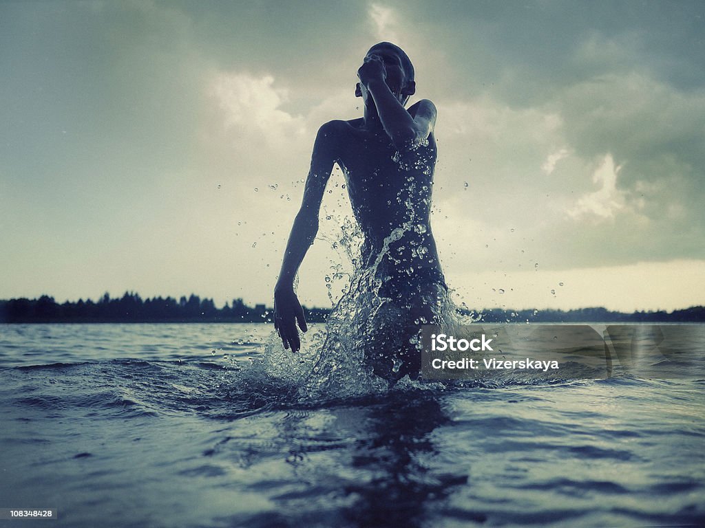 jumping boy in water  Child Stock Photo