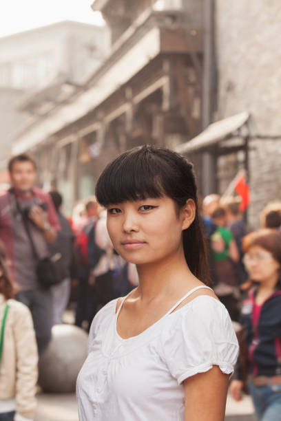 istock Serious Chinese woman standing in downtown 1083484852