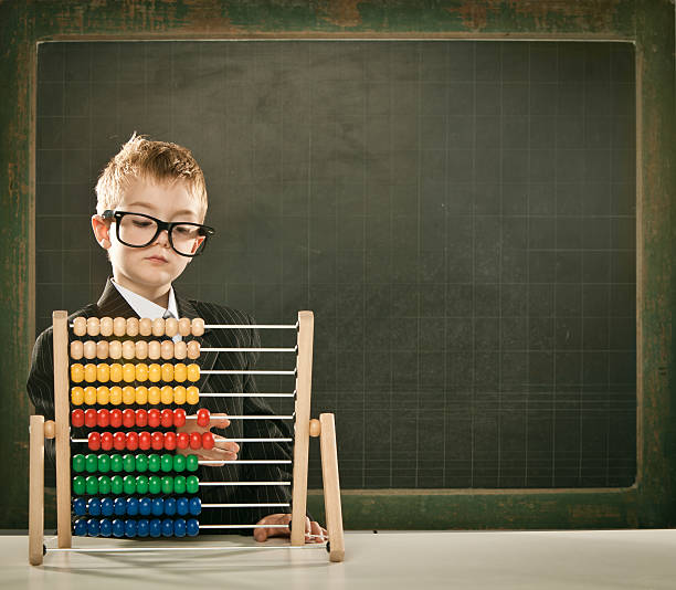 istock young serious scientist child with abacus and copyspace blackboa 108348567