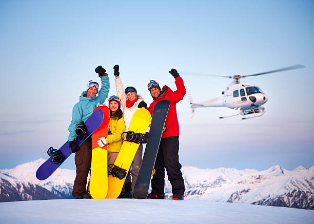 heli ski snowboarders - heliskiing bildbanksfoton och bilder