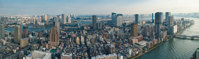 Aerial view over the Tokyo waterfront, the Sumida-gawa river, Tsukishima, Kachidoki-bashi bridge and the port and bay beyond. ProPhoto RGB profile for maximum color fidelity and gamut.