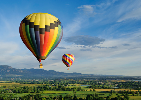 A beautiful hot air balloon floating in the sky on a lovey summer evening.