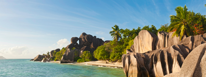 The famous sculpted granite rocks, warm white sands, swaying palms and clear turquoise waters of the idyllic tropical beach and island lagoon at Anse Source d'Argent, La Digue, Seychelles. ProPhoto RGB profile for maximum color fidelity and gamut.