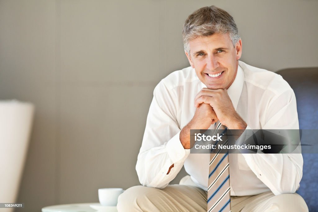 Middle-Aged Businessman Sitting Confidently  40-49 Years Stock Photo