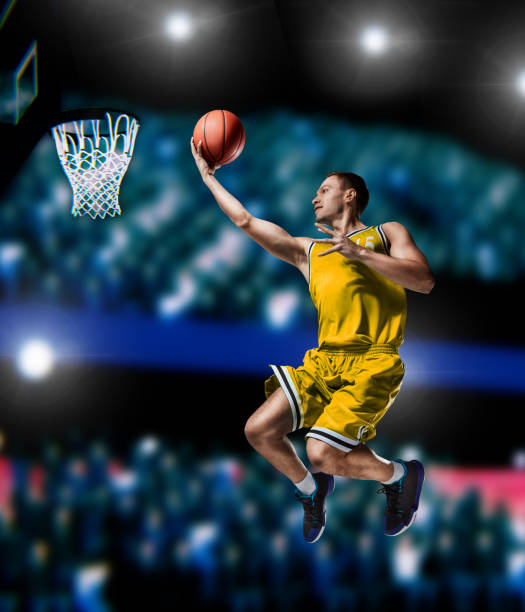 istock basketball player making slam dunk on basketball arena 1083495954
