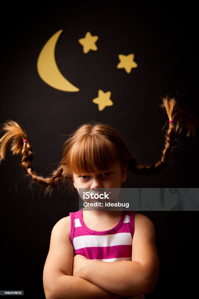 Grumpy Girl with Upward Braids Standing Under Moon and Stars  Anger Stock Photo