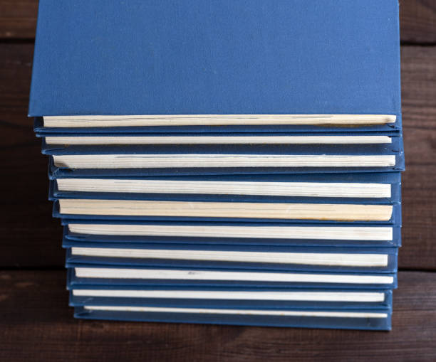 istock large stack of books in a blue cover on a brown wooden table 1083498258