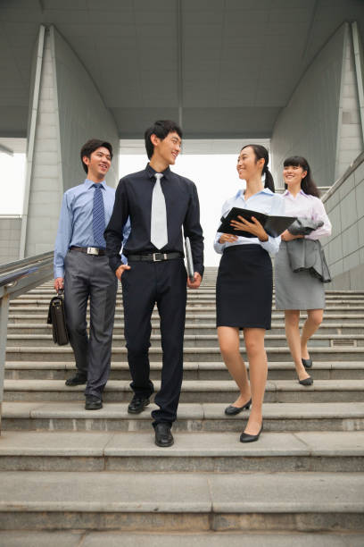istock Chinese business people talking on city steps 1083502606