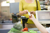 Cashier handing receipt to customer