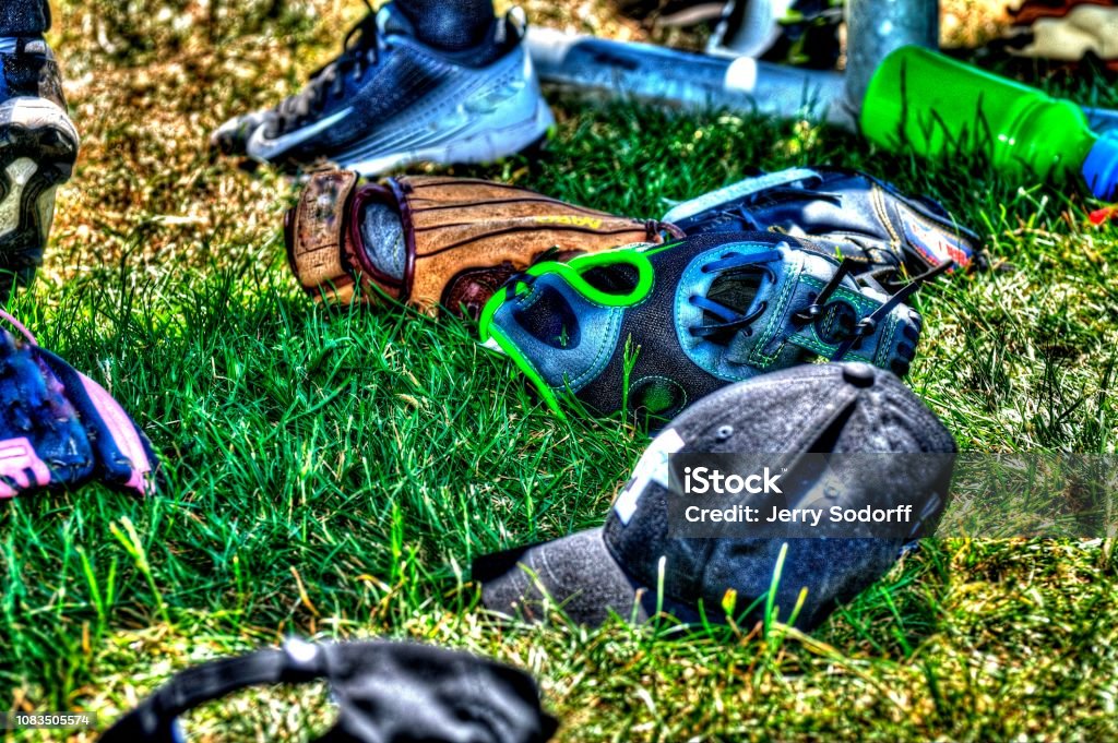 Youth baseball equipment Youth baseball equipment laying on grass Baseball - Sport Stock Photo
