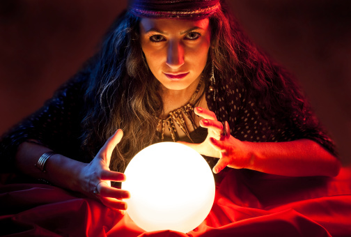 Cropped image of fortune teller reading tarot card