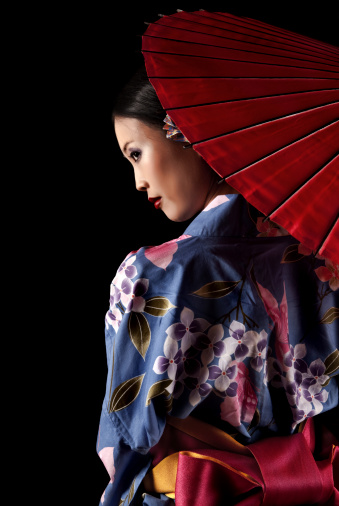 Japanese geisha with a red umbrella, Tokyo, Japan.