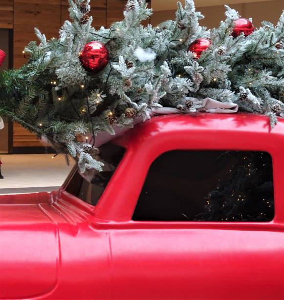 istock Christmas Tree and Greenery with Red Truck 1083510626
