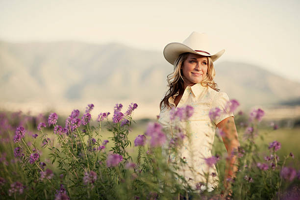 Portrait of beautiful western girl in a summer field. 