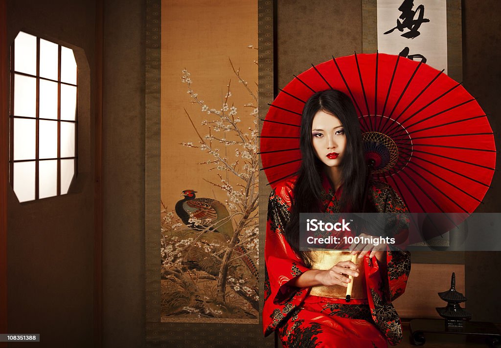 Beautiful Japanese geisha with a red umbrella Beautiful Japanese geisha  with a red umbrella, Tokyo, Japan. Geisha Stock Photo