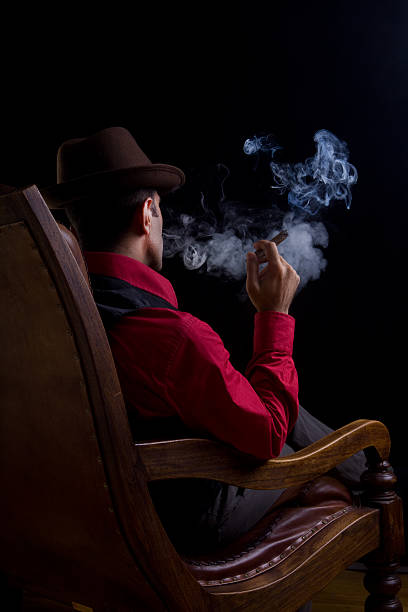 vista trasera del hombre sentado en un sillón para fumadores y no fumadores - copy space one person vertical 1970s style fotografías e imágenes de stock
