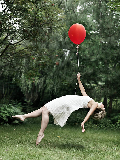 istock Young woman holding a balloon 108352062