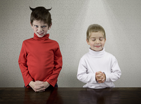 Studio shot of a 6 year old boy with an angry expression.  