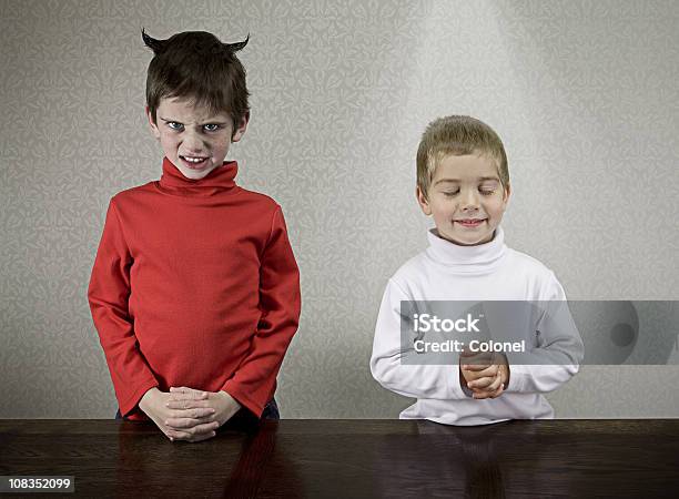 Sibling Personalities Stock Photo - Download Image Now - Hands Clasped, Devil, Angel