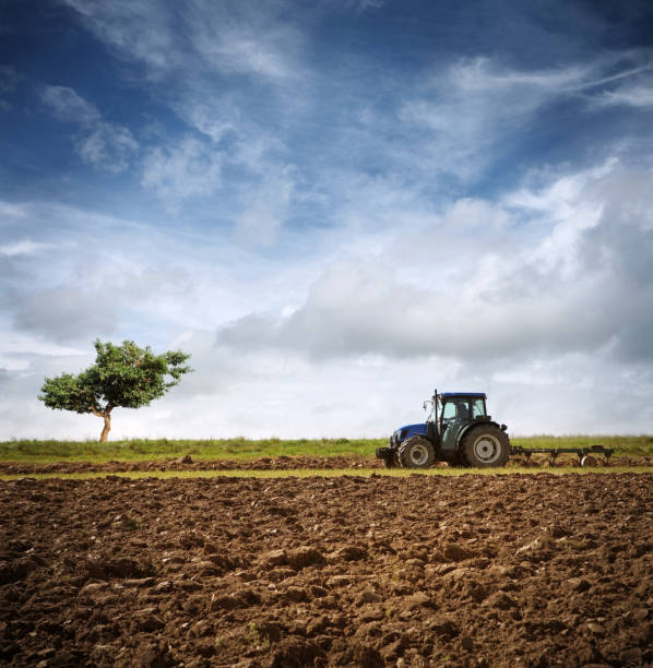 Tractor Ploughing on the Field  cultivated land photos stock pictures, royalty-free photos & images