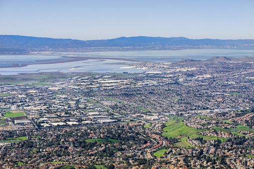 Aerial view of Fremont and Newark on the shoreline of east San Francisco bay area; Dumbarton bridge in the background; Silicon Valley, California