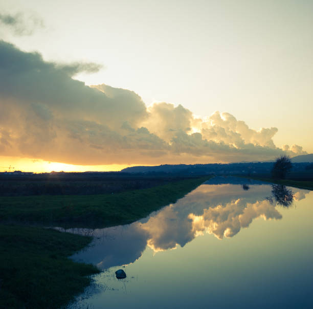 rain drops and cloudstorm over the Po river in Piacenza, Emilia Romagna, Italy at sunset