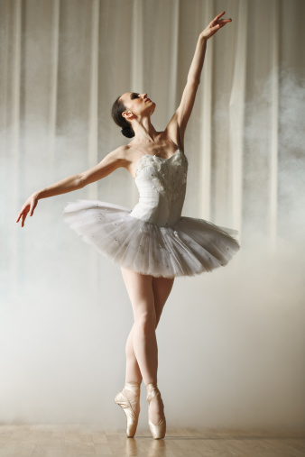 modern ballerina female dancer jumping split in the air, studio shot