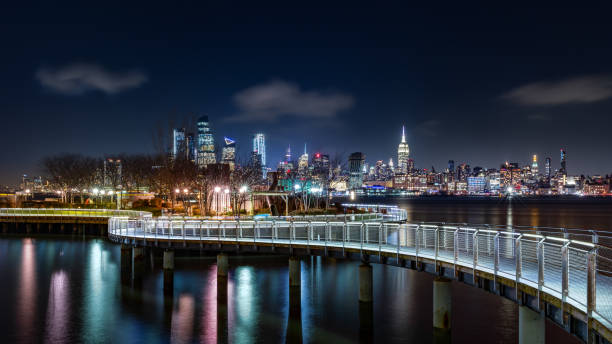 Pier C park in Hoboken, New Jersey Pier C park in Hoboken, New Jersey by night, with the New York City skyline in the background. promenade photos stock pictures, royalty-free photos & images