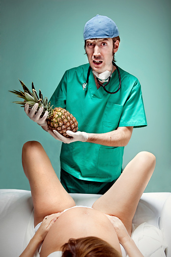 Woman giving birth to a pineapple