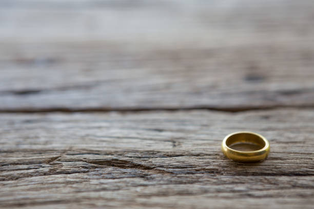 istock Gold ring on wooden background 1083528208