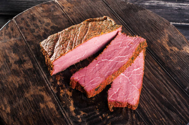 istock Delicious ham on a dark wooden background 1083532786