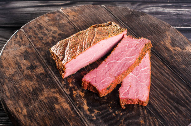 istock Delicious ham on a dark wooden background 1083533242