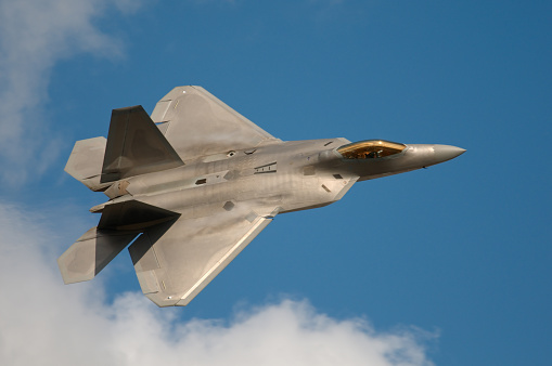 OshKosh, United States – July 29, 2022: Low-angle shot of F-18 variant military fighter plane flying in the sky above Wittman Regional Airport