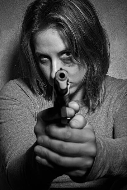 istock Abused woman protecting herself with a gun 108353687