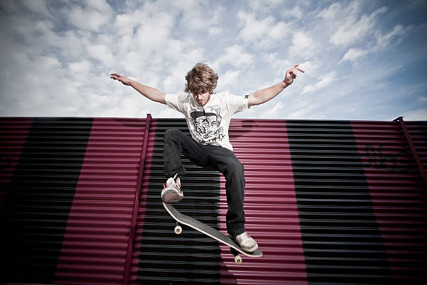 Young skateboarder jumping stock photo