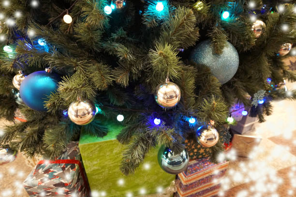 istock christmas tree and small and decoration with many gift box in  bokeh light background 1083537854