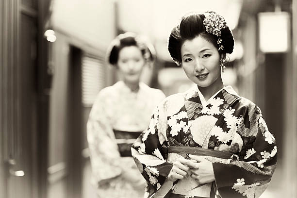 Two beautiful Japanese sisters dressed in the traditional kimono dress. Kyoto, Japan.
