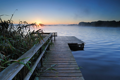 Dock on Lake at Moody Sunrise, Mist rising from Water