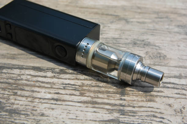 istock E - cigarette for vaping , technical devices.The liquid in the bottle 1083539130