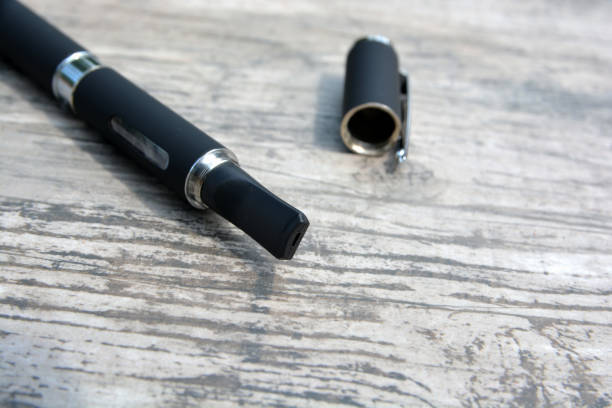 istock E - cigarette for vaping , technical devices.The liquid in the bottle 1083539132
