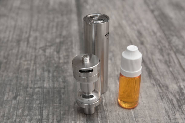 istock E - cigarette for vaping , technical devices.The liquid in the bottle 1083539168