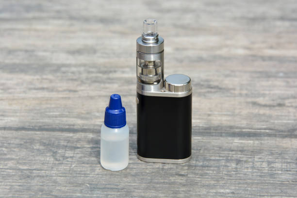 istock E - cigarette for vaping , technical devices.The liquid in the bottle 1083539220